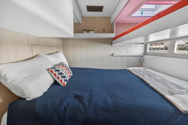  Yacht Photos Pics Cozy bedroom in 2019 Leopard 58 yacht with blue bedding and decorative pillows.