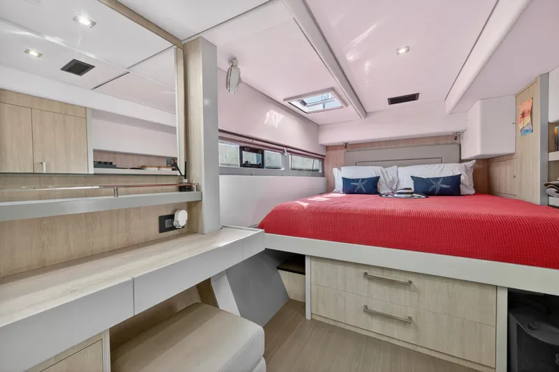  Yacht Photos Pics Luxurious 2019 Leopard 58 yacht bedroom with red bedding and modern wood accents.
