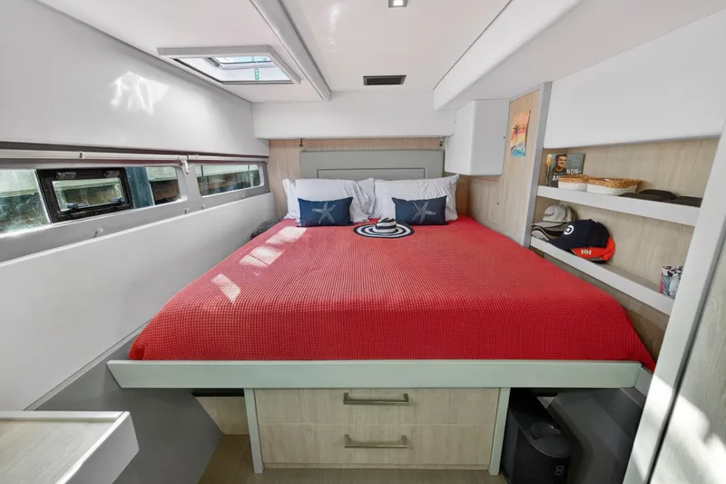  Yacht Photos Pics Luxurious bedroom interior of 2019 Leopard 58 yacht with red bedding and modern decor.
