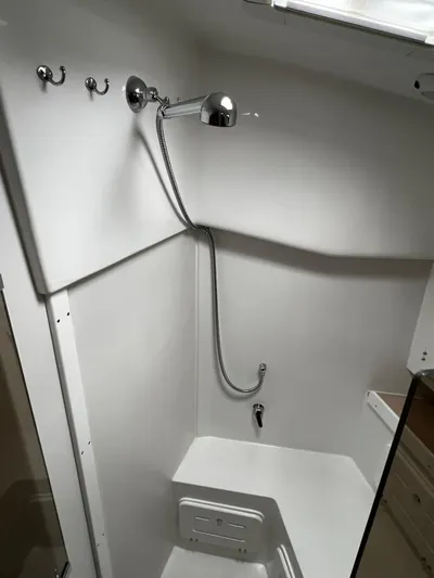395 Yacht Photos Pics Compact shower area in a 2025 Tartan 395 yacht, featuring modern fixtures and white interior.