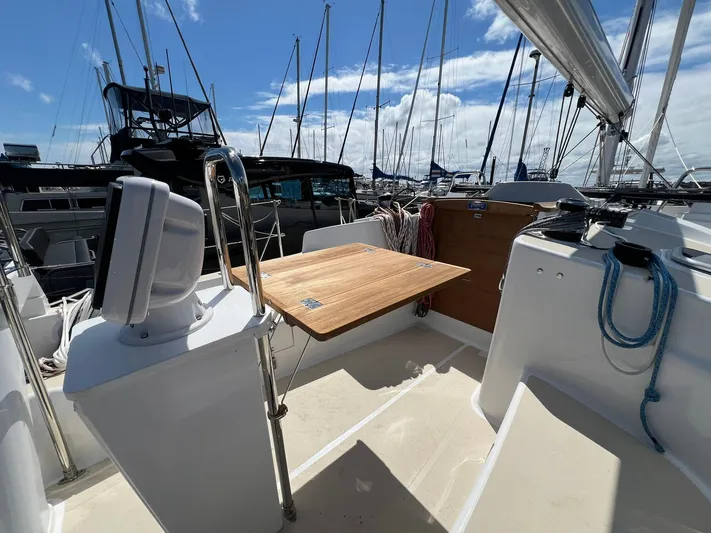 395 Yacht Photos Pics Sailboat cockpit of 2025 Tartan 395 with wooden table, marina background.