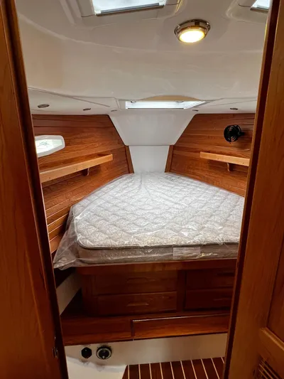 395 Yacht Photos Pics 2025 Tartan 395 yacht cabin with wooden interior and cozy bed.