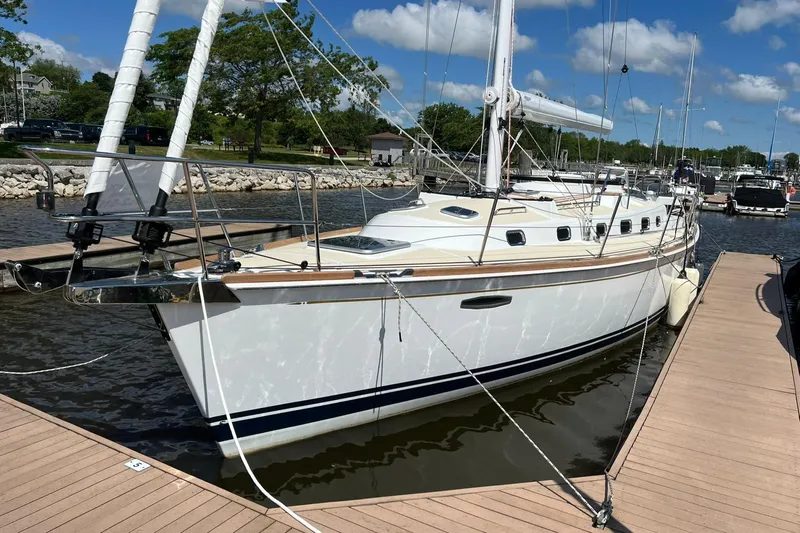 395 Yacht Photos Pics 2025 Tartan 395 sailboat docked in a marina under a clear blue sky.