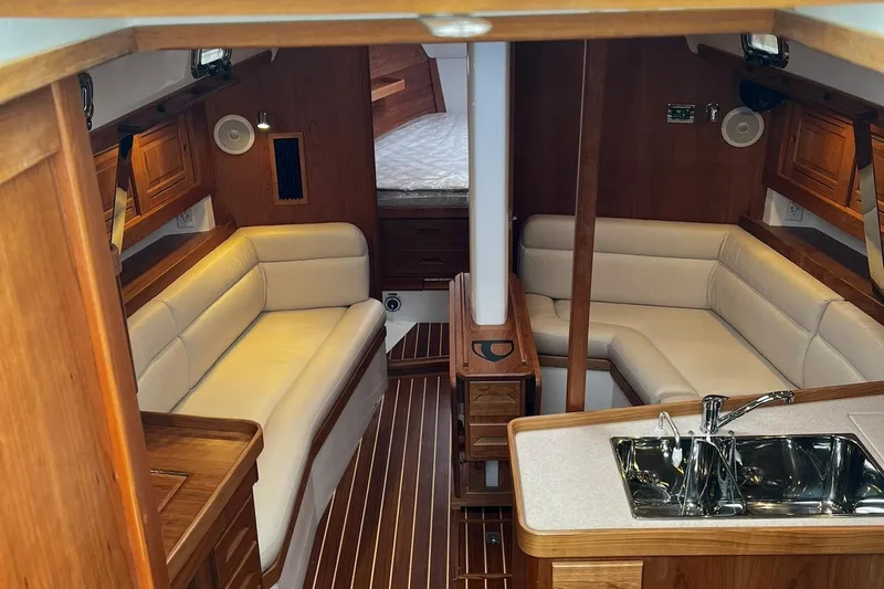 395 Yacht Photos Pics Luxurious interior of 2025 Tartan 395 yacht with elegant wood finish and plush seating.