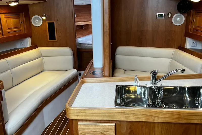 395 Yacht Photos Pics Interior of 2025 Tartan 395 yacht with modern seating and kitchen area.
