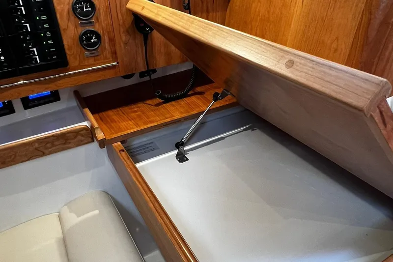 395 Yacht Photos Pics Tartan 395 (2025) interior with wooden cabinetry and storage compartment.