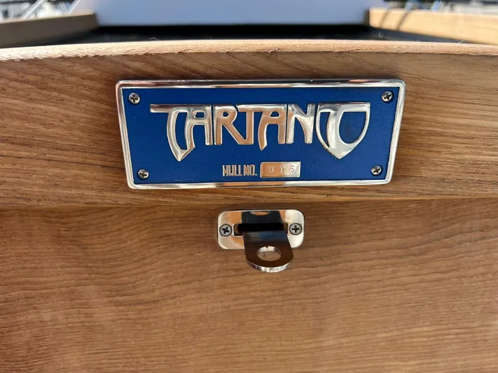 395 Yacht Photos Pics Tartan 395 boat nameplate on wooden surface, model year 2025.