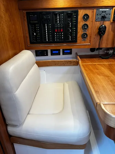 395 Yacht Photos Pics Interior of 2025 Tartan 395 yacht with control panel and cushioned seating.