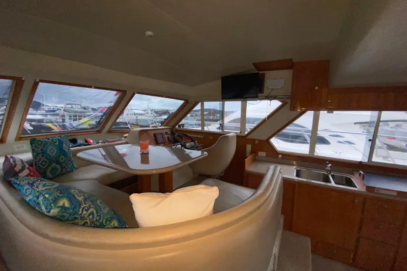 It's About Time Yacht Photos Pics Interior of 2001 Californian 39 yacht with seating, helm, and kitchenette.