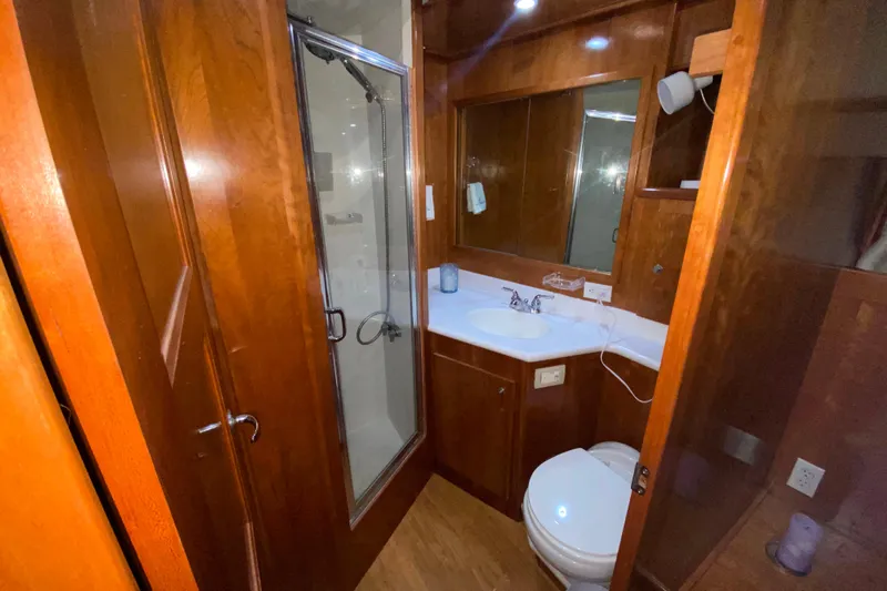 It's About Time Yacht Photos Pics Luxurious wooden bathroom interior in 2001 Californian 39 yacht, featuring shower and vanity.