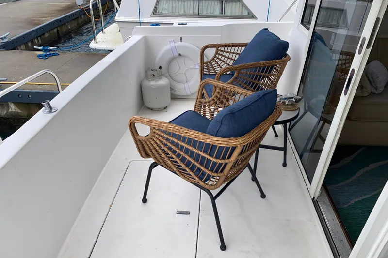It's About Time Yacht Photos Pics Deck of 2001 Californian 39 yacht with wicker chairs and blue cushions.