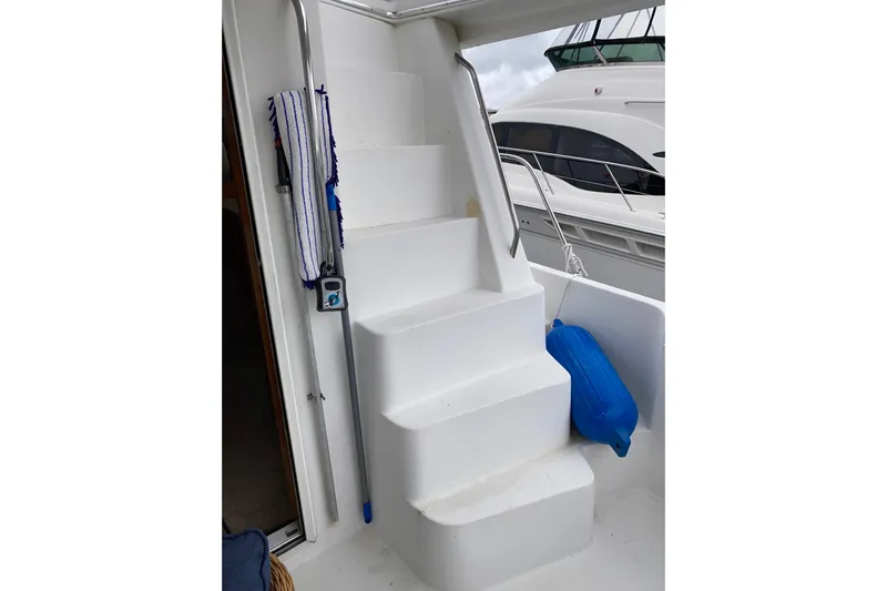 It's About Time Yacht Photos Pics Staircase on 2001 Californian 39 yacht with blue fender and cleaning tools.