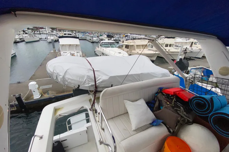 It's About Time Yacht Photos Pics 2001 Californian 39 yacht interior with marina view, featuring seating and covered equipment.