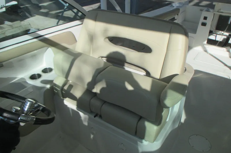  Yacht Photos Pics 2019 Sailfish 325 DC boat interior with beige seating and steering wheel.
