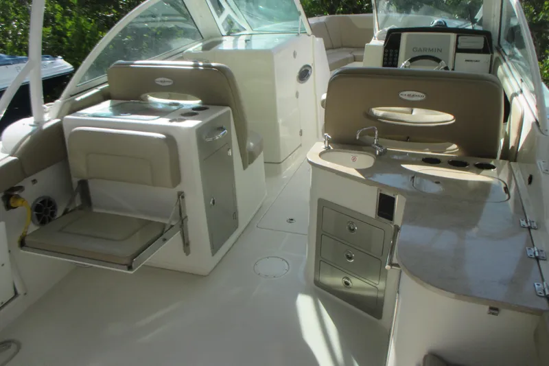  Yacht Photos Pics 2019 Sailfish 325 DC boat interior with seating, sink, and navigation equipment.