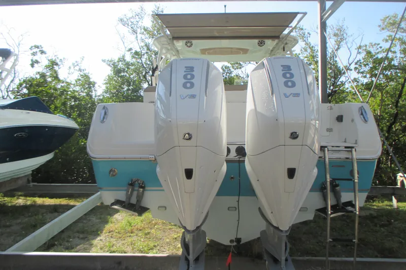  Yacht Photos Pics 2019 Sailfish 325 DC boat with twin 300 V8 engines, docked outdoors.