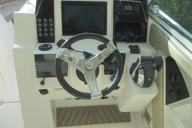  Yacht Photos Pics 2019 Sailfish 325 DC boat helm with steering wheel and control panel.