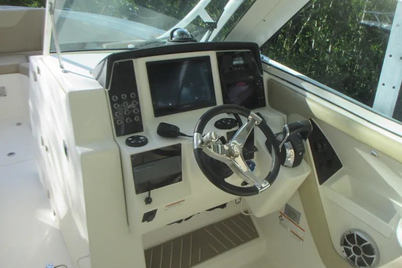  Yacht Photos Pics 2019 Sailfish 325 DC boat cockpit with steering wheel and control panel.