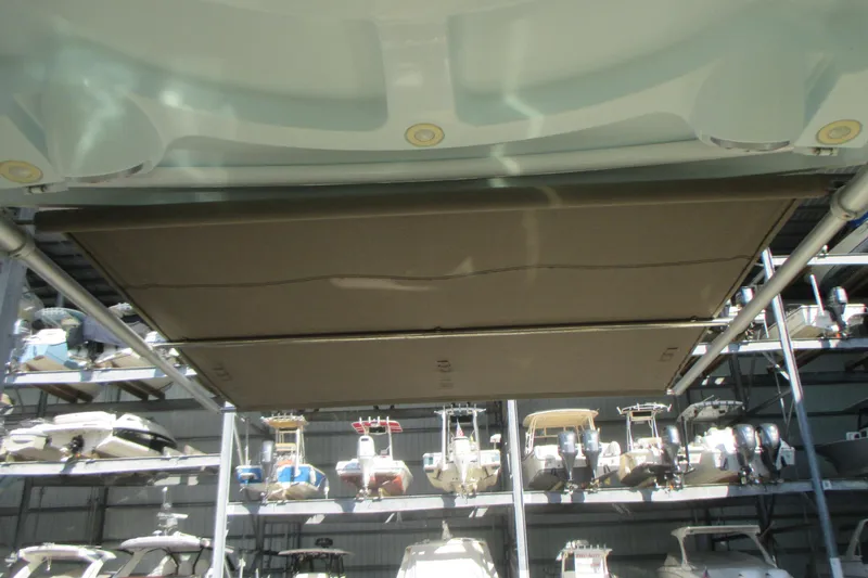  Yacht Photos Pics 2019 Sailfish 325 DC boat with retractable sunshade in storage facility.