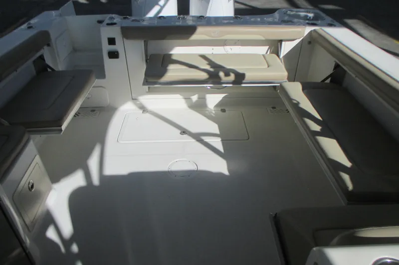  Yacht Photos Pics 2019 Sailfish 325 DC boat interior with cushioned seating and storage compartments.