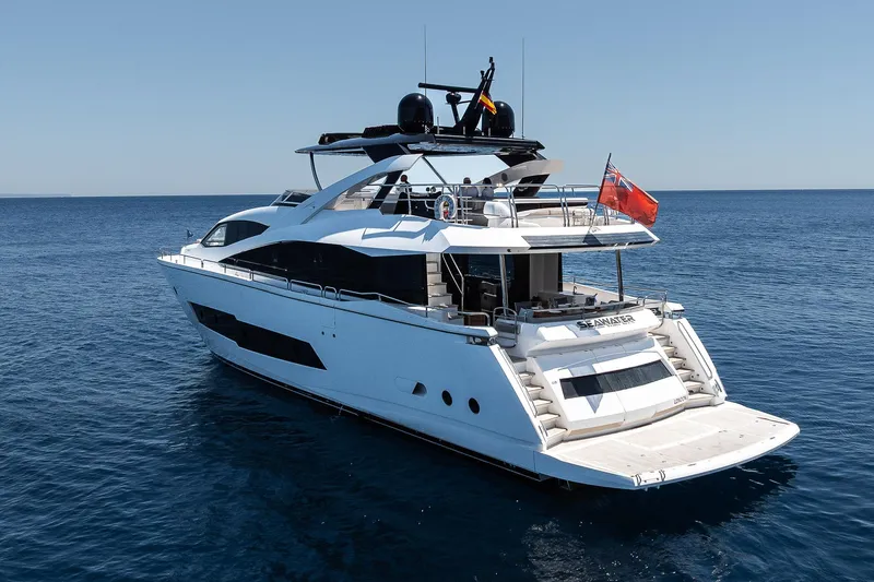 Seawater Yacht Photos Pics 2019 Sunseeker 86 Yacht cruising on open sea, rear view.