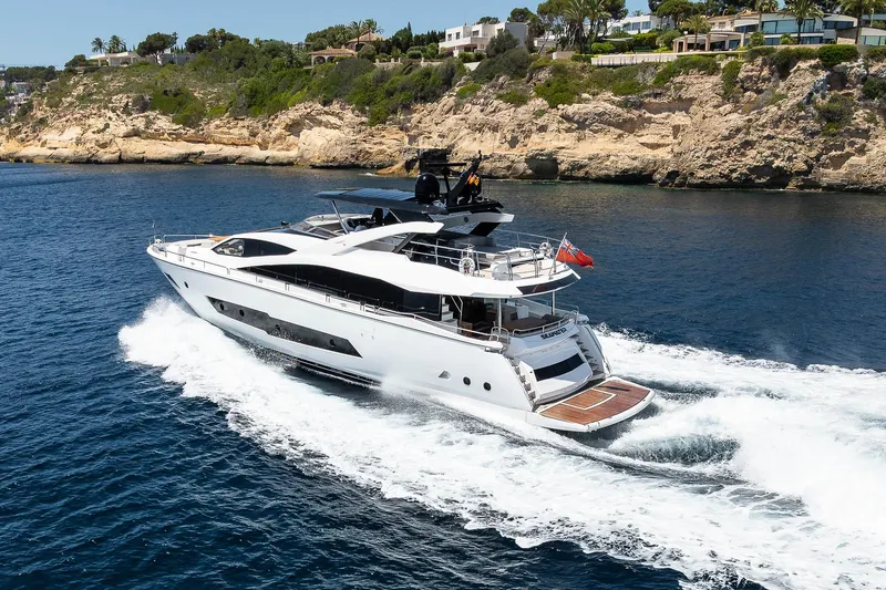 Seawater Yacht Photos Pics Luxurious 2019 Sunseeker 86 Yacht cruising along a scenic rocky coastline.