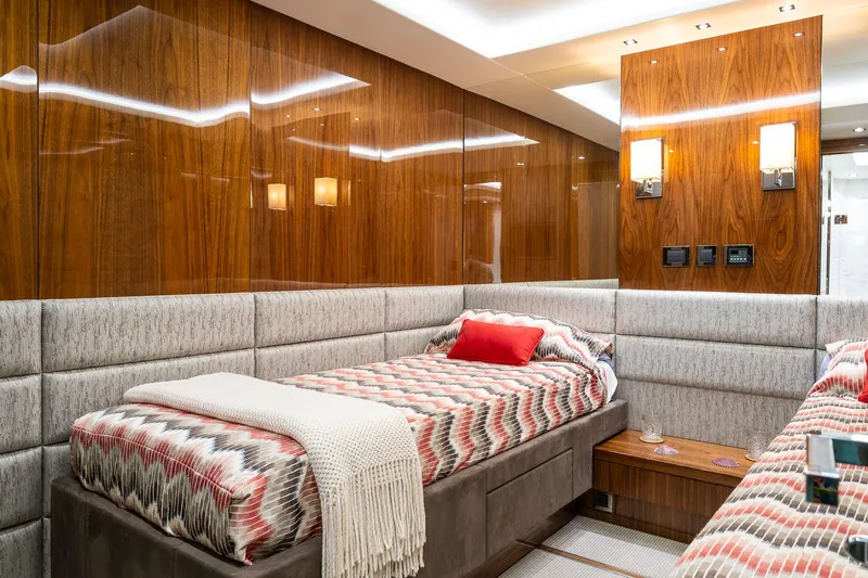 Seawater Yacht Photos Pics Luxurious cabin interior of 2019 Sunseeker 86 Yacht with wood paneling and twin beds.