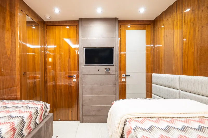 Seawater Yacht Photos Pics Luxurious Sunseeker 86 Yacht 2019 interior with twin beds and modern wood paneling.