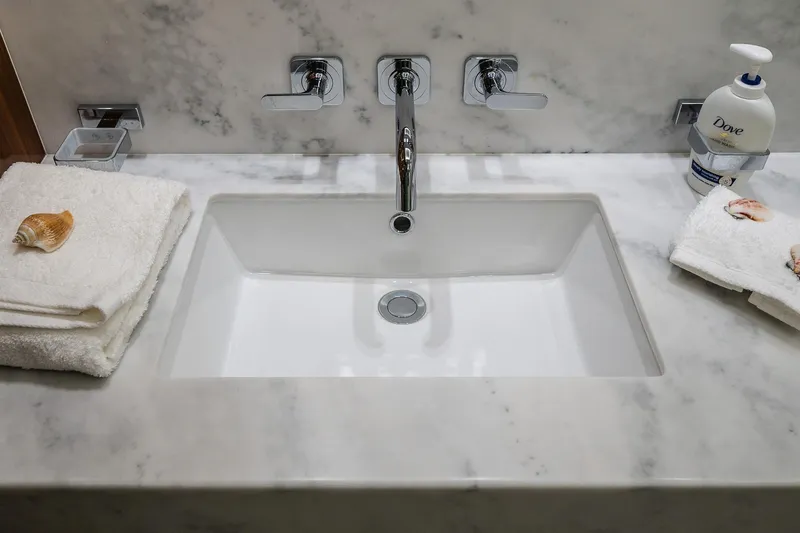 Seawater Yacht Photos Pics Luxurious marble sink area on 2019 Sunseeker 86 Yacht, featuring elegant fixtures and toiletries.