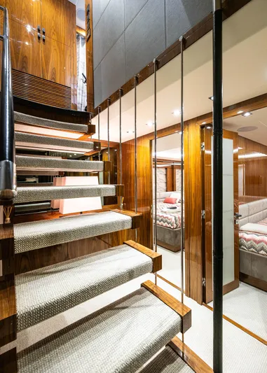 Seawater Yacht Photos Pics Luxurious interior of 2019 Sunseeker 86 Yacht with modern staircase and elegant wood finishes.