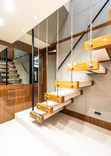 Seawater Yacht Photos Pics Modern staircase on 2019 Sunseeker 86 Yacht, featuring sleek wood and metal design.