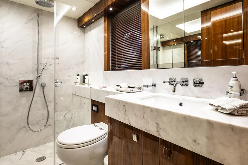 Seawater Yacht Photos Pics Luxurious bathroom in 2019 Sunseeker 86 Yacht with marble and wood finishes.