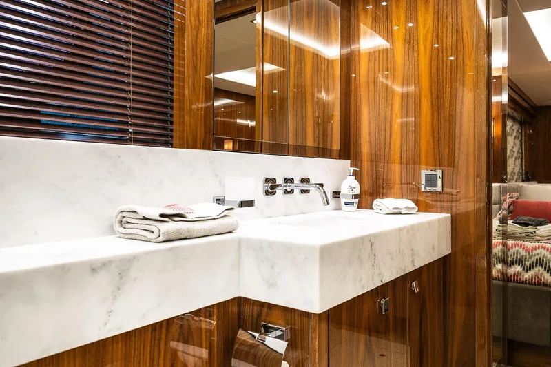 Seawater Yacht Photos Pics Luxurious bathroom in 2019 Sunseeker 86 Yacht with marble sink and wooden accents.