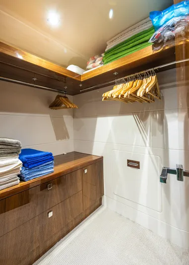 Seawater Yacht Photos Pics Luxurious walk-in closet on 2019 Sunseeker 86 Yacht with wooden shelves and hangers.