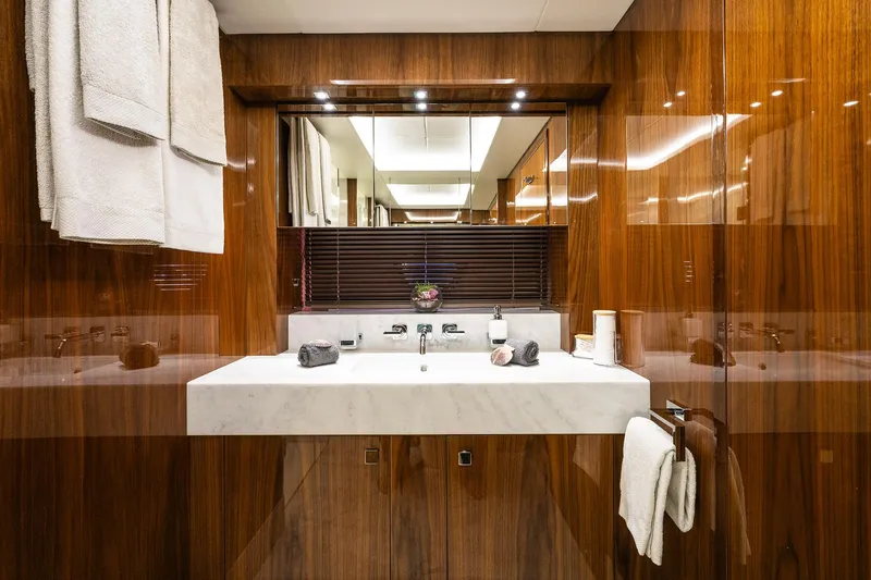 Seawater Yacht Photos Pics Luxurious bathroom in 2019 Sunseeker 86 Yacht with elegant wood paneling and modern fixtures.