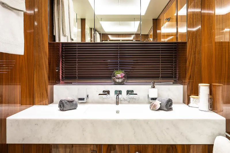 Seawater Yacht Photos Pics Luxurious bathroom on 2019 Sunseeker 86 Yacht with marble sink and wooden accents.