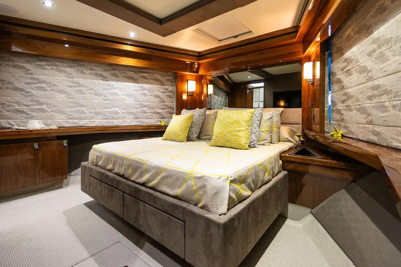 Seawater Yacht Photos Pics Luxurious bedroom interior of 2019 Sunseeker 86 Yacht with elegant wood finishes.