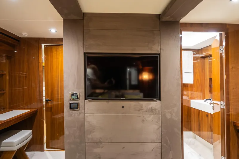 Seawater Yacht Photos Pics Luxurious interior of 2019 Sunseeker 86 Yacht featuring modern TV and elegant wood finishes.