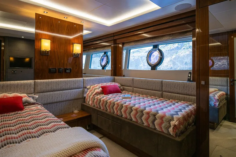 Seawater Yacht Photos Pics Luxurious 2019 Sunseeker 86 Yacht cabin with twin beds and elegant wood paneling.