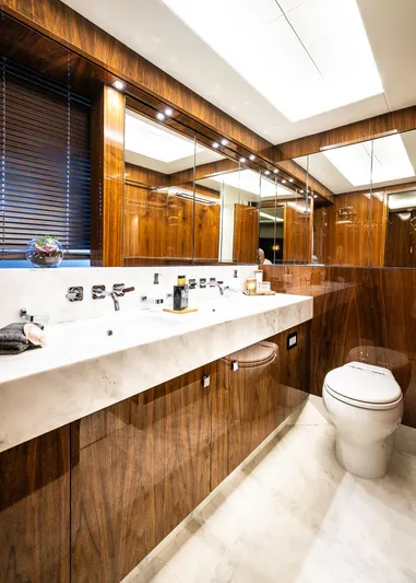 Seawater Yacht Photos Pics Luxurious bathroom in 2019 Sunseeker 86 Yacht with elegant wood finishes and modern fixtures.