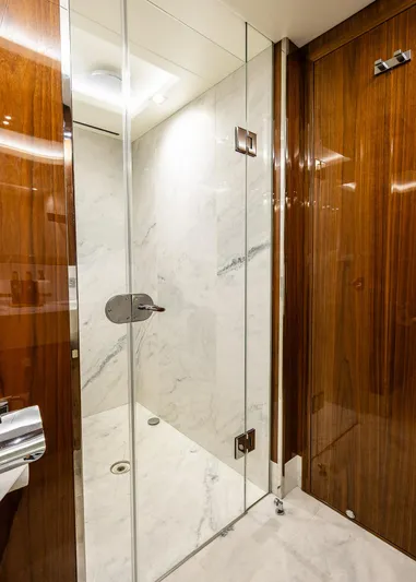 Seawater Yacht Photos Pics Luxurious marble shower in 2019 Sunseeker 86 Yacht with glass enclosure and wooden accents.
