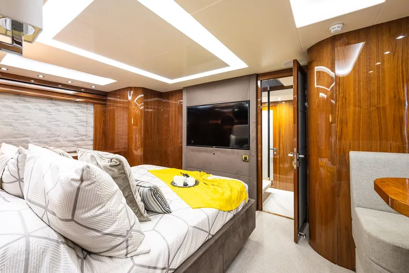 Seawater Yacht Photos Pics Luxurious Sunseeker 86 Yacht 2019 bedroom with modern decor and elegant wood paneling.