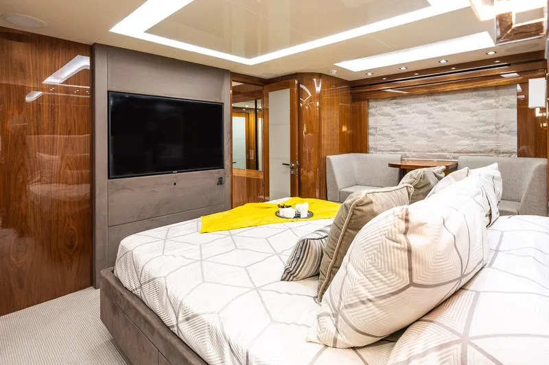 Seawater Yacht Photos Pics Luxurious bedroom interior of 2019 Sunseeker 86 Yacht with modern decor and large TV.