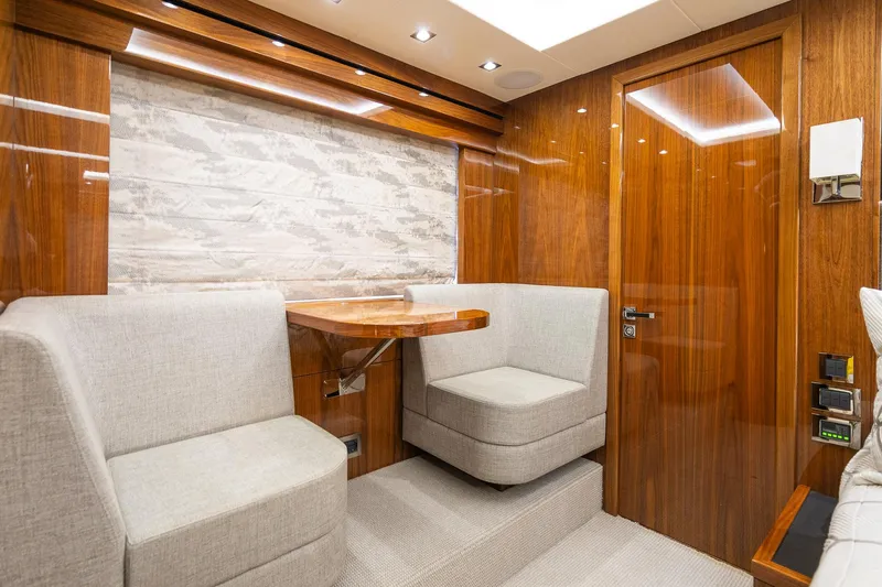 Seawater Yacht Photos Pics Luxurious interior of 2019 Sunseeker 86 Yacht with elegant wood paneling and plush seating.