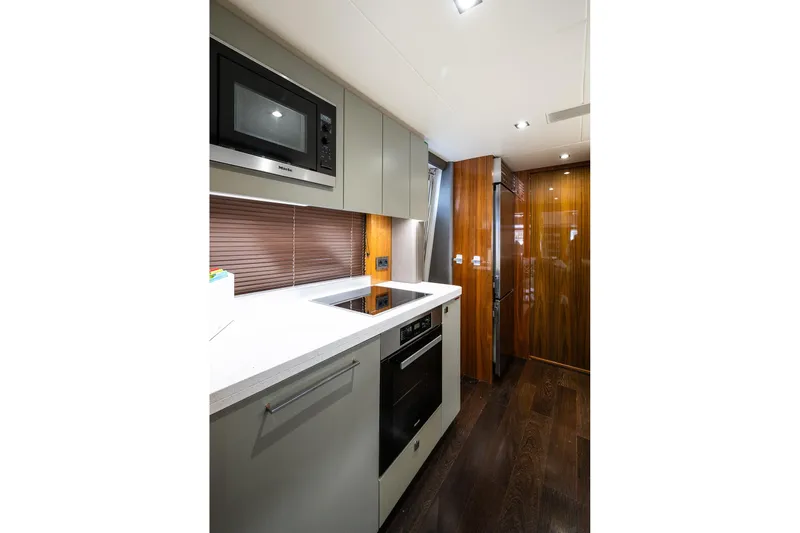 Seawater Yacht Photos Pics Modern kitchen interior of 2019 Sunseeker 86 Yacht with sleek appliances and wood accents.