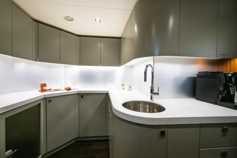 Seawater Yacht Photos Pics Modern kitchen interior on 2019 Sunseeker 86 Yacht, featuring sleek cabinetry and appliances.