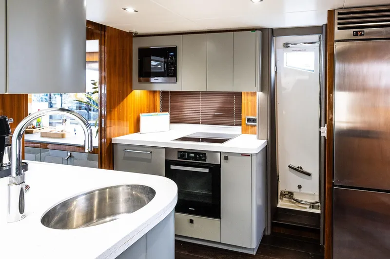 Seawater Yacht Photos Pics Luxurious kitchen interior of 2019 Sunseeker 86 Yacht with modern appliances and sleek design.