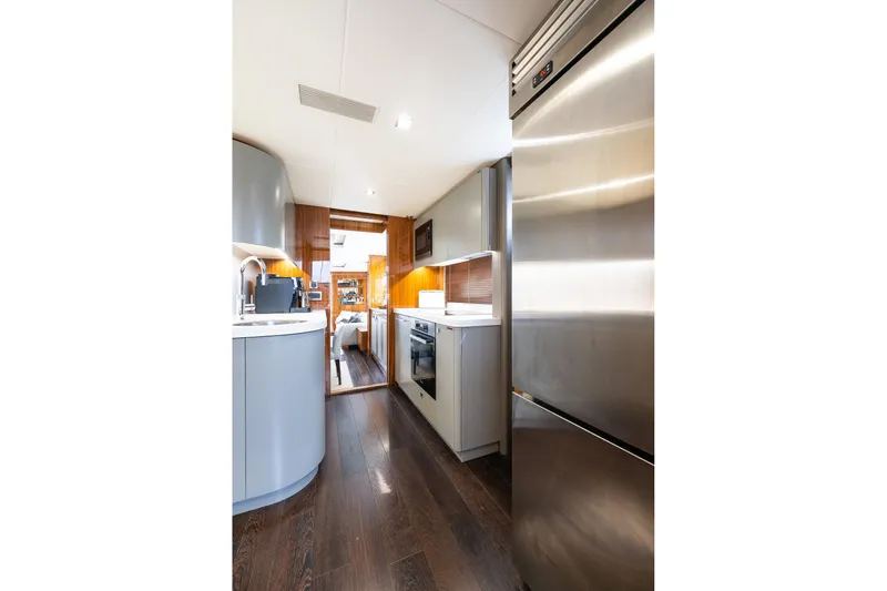 Seawater Yacht Photos Pics Luxurious kitchen interior of 2019 Sunseeker 86 Yacht with modern appliances and sleek design.