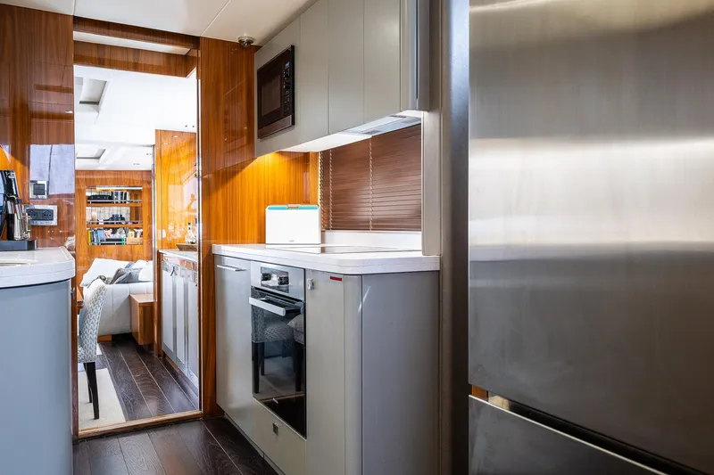 Seawater Yacht Photos Pics Luxurious kitchen interior of 2019 Sunseeker 86 Yacht with modern appliances and sleek design.