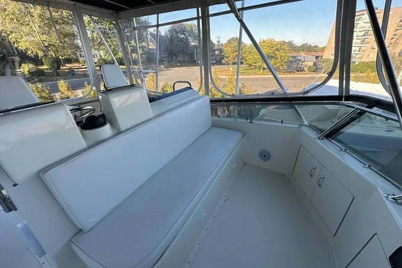 Summer Shack Yacht Photos Pics 1988 Hatteras 48 Convertible boat interior with white seating and panoramic windows.